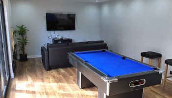 Games room with mini pool table home cinema and bar